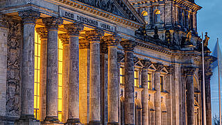 The entrance portal of the Reichstag in Berlin at twilight