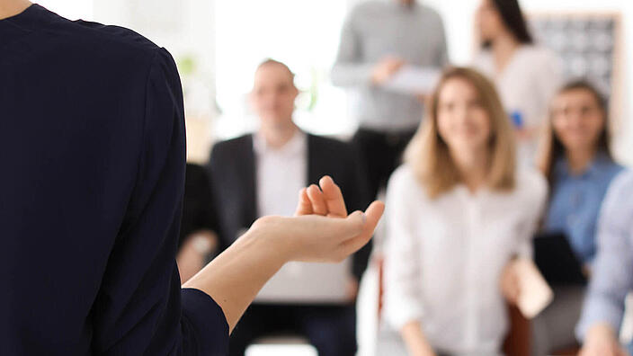 Female business trainer giving lecture in office