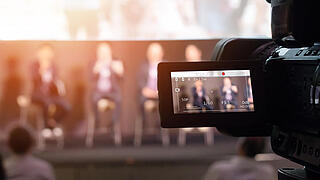 Video Presentation media and live streaming record and broadcast in real time for social network concept. VDO camera taking live video streaming at seminar technology event with flare light effect.