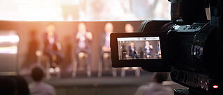 Video Presentation media and live streaming record and broadcast in real time for social network concept. VDO camera taking live video streaming at seminar technology event with flare light effect.