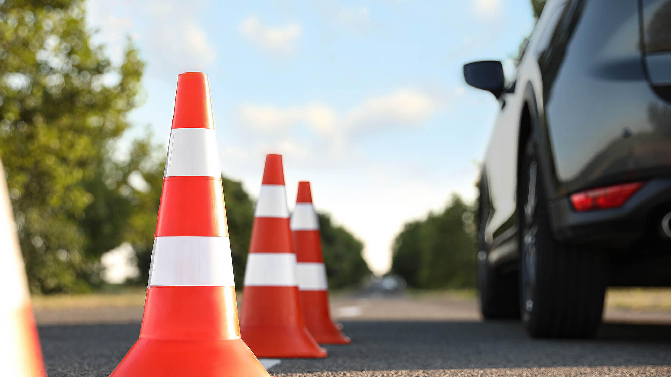 Traffic cones near car outdoors. Driving school exam
