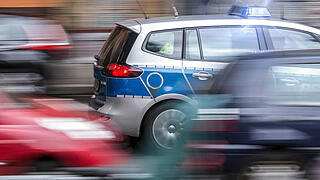 german police car speeding in city traffic