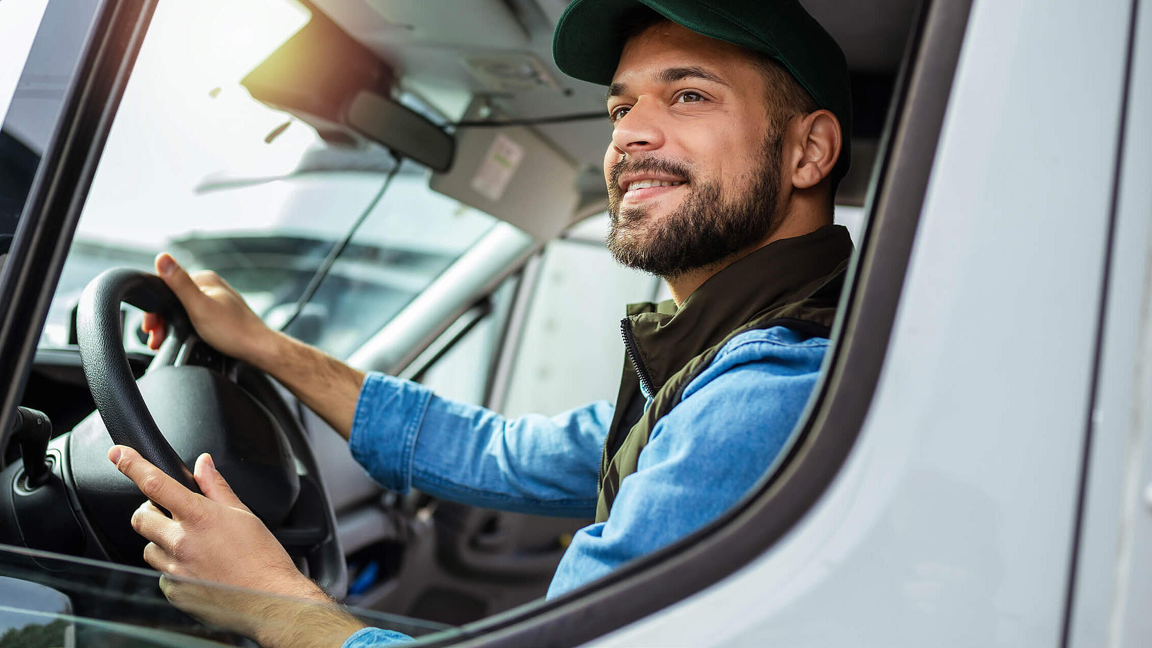 Young handsome man working in towing service and driving his truck.