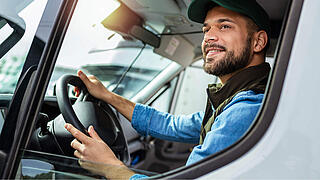 Young handsome man working in towing service and driving his truck.